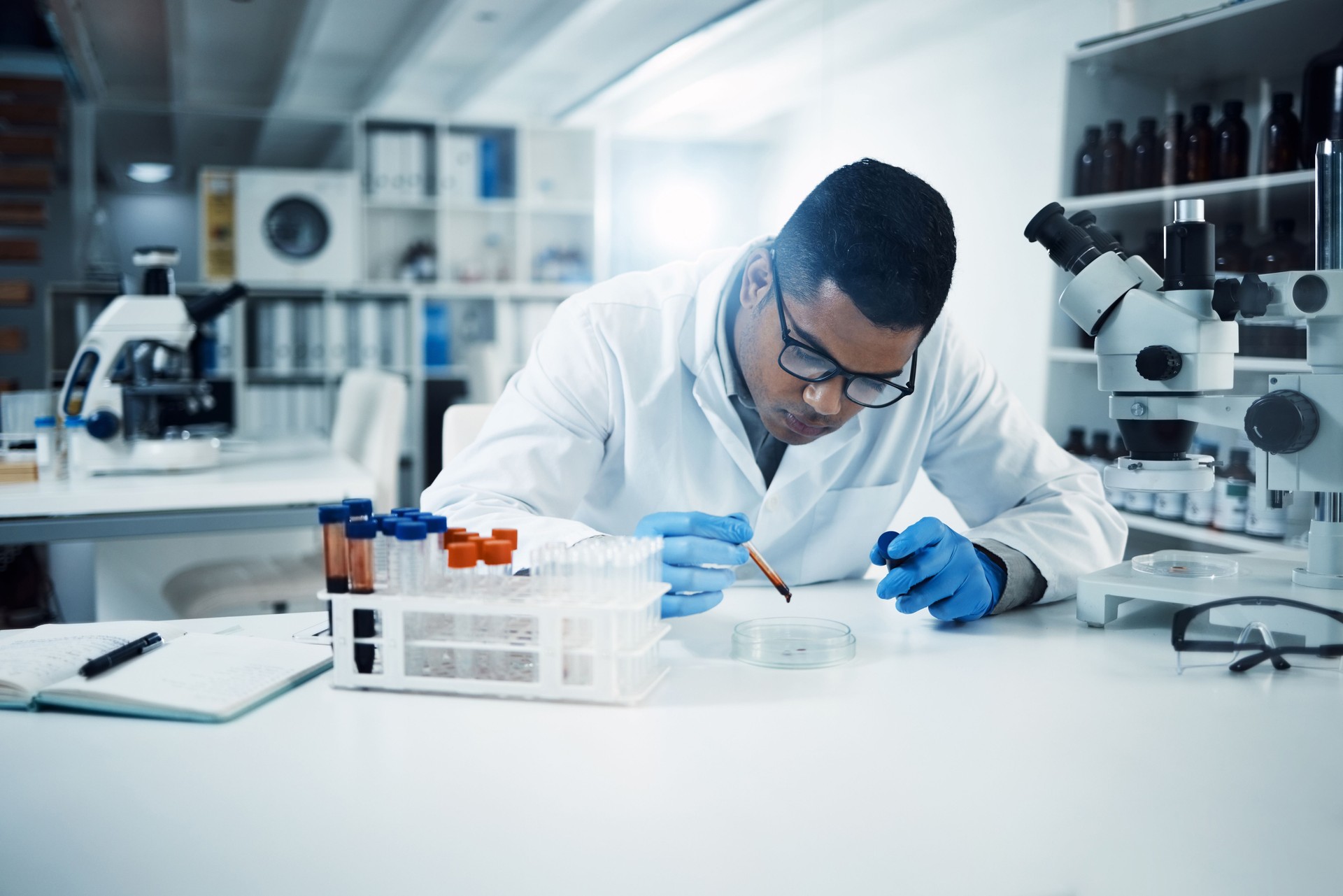 Shot of a young scientist conducting medical research on blood in a laboratory